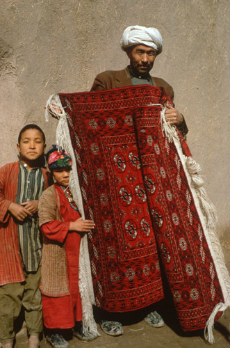 Afghanistan, Herat, Turcoman with carpet woven by wives